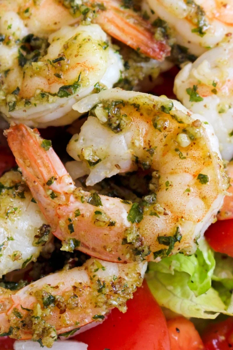 This 5 Minute Pesto Shrimp recipe is an easy, healthy, delicious way to prepare shrimp in just minutes! It's great served on a salad or as an accompaniment to steak. #shrimp #seafood