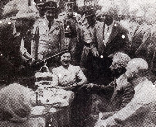 Quaid-e-Azam receiving a rifle from a tribal chief