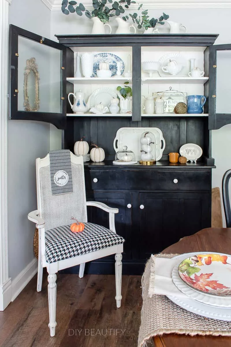 black hutch with white pumpkins