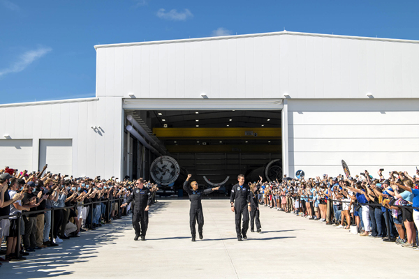 The Inspiration4 crew walks out of the Horizontal Integration Facility as hundreds of SpaceX employees, friends and well-wishers give them a special send-off before launch...on September 15, 2021.