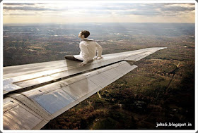 Funny Pic  Without ticket around the world.   A man sitting on a airplane wing trying to journey around the world.