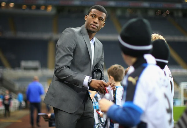 Georginio Wijnaldum of Newcastle United signs autographs for young fans prior to the Barclays Premier League match between Newcastle United and Aston Villa at St James' Park on December 19, 2015 in Newcastle upon Tyne, England