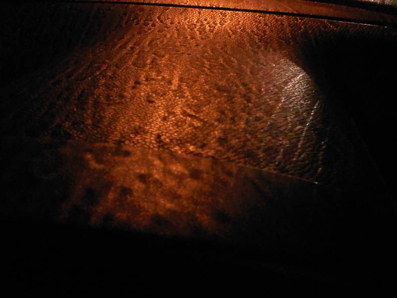 Sodium street light reflected off dashboard of car