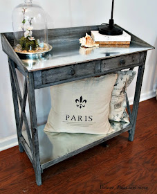 rustic table with galvanized sheeting for top and shelf used in a vintage industrial setting