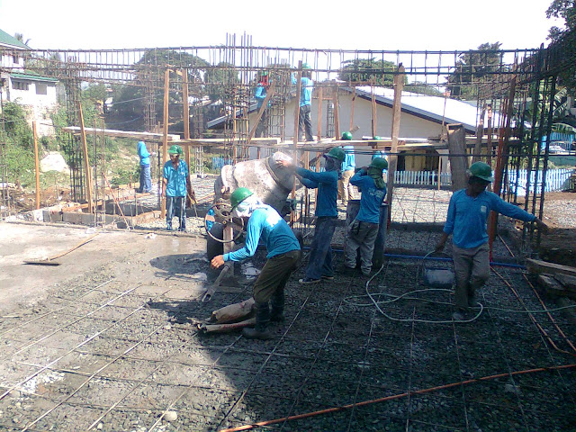 Construction workers concreting slab on grade