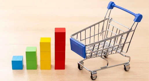Sales graphs and silver plated shopping cart.