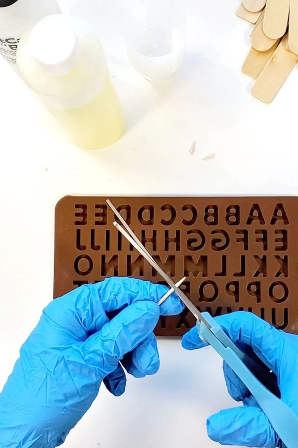 STEP 1: CUT TOOTHPICKS   Begin by cutting the pointed end of the toothpicks off with some scissors.    The cut-off blunt end will be inserted into the resin while curing to latch into the letterboard.    The resin cures so quickly, these toothpick pieces must be ready to use.