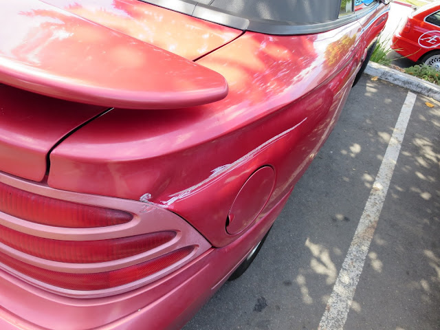 Deep scrape in quarter panel on 1995 Ford Mustang before repairs at Almost Everything Auto Body