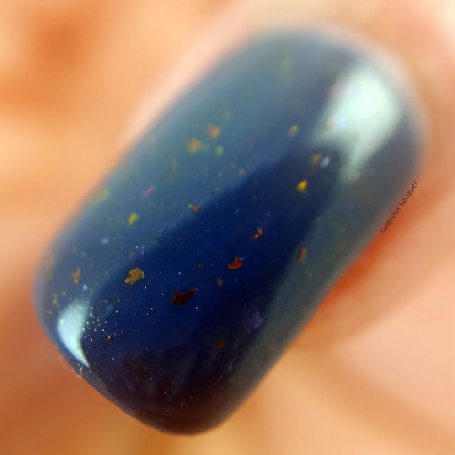 dark-blue-nail-polish-with orange-and-gold-flakes-and-pink-shimmer