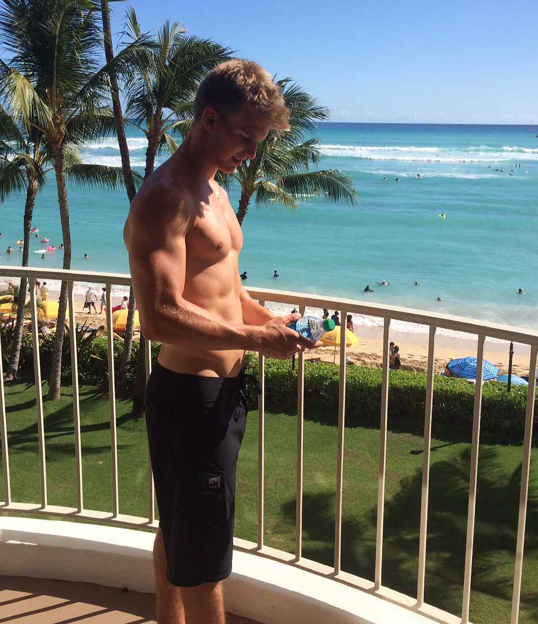 shirtless-skinny-fit-sexy-young-guy-vacation-hotel-room-balcony-view-beautiful-sea