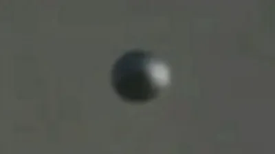 A close up of a UFO sphere overNew York.