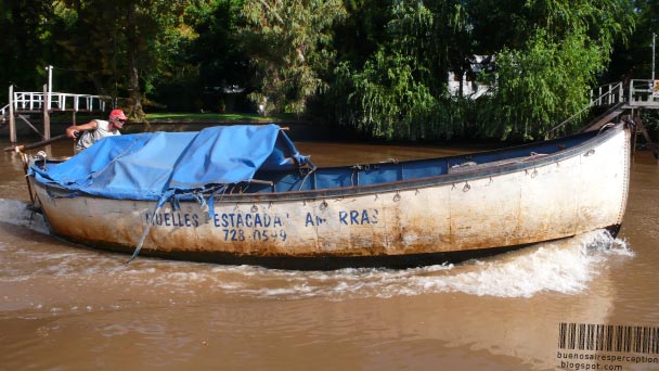 Man Maneuvering his Motor Boat in the Paraná Delta in Tigre near Buenos Aires, Argentina