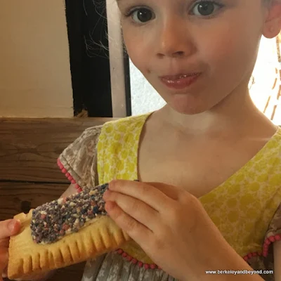 child downs a pop tart at Bakery Lorraine in the Pearl in San Antonio, Texas