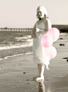 Girl with Pink Balloons on the Beach - has Down Syndrome