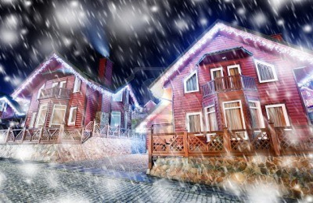 Casas con luces y cayendo nieve