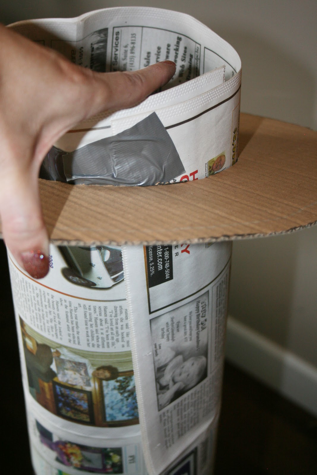 made a tube out of the newspaper that fit into the ring of the hat ...