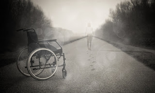 grey and white photo an empty wheelchair and footsteps leading away from it left by a figure at a distance