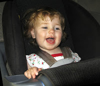 child in car seat smiling