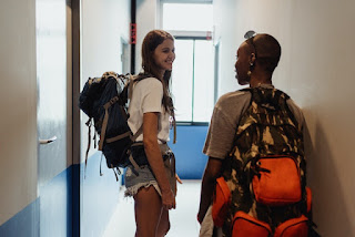 Two students standing in front of their dorm room