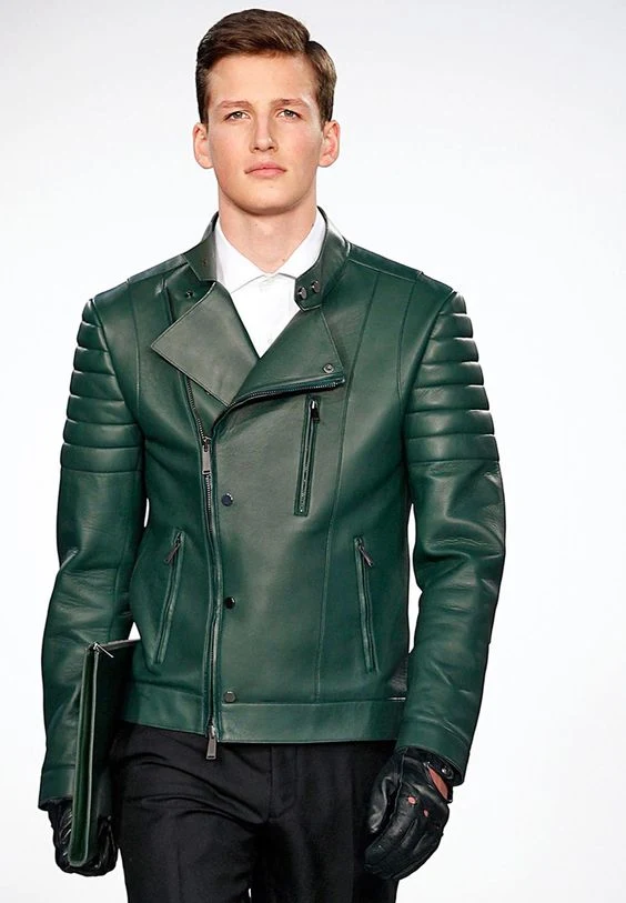 Handsome young man in sexy green leather biker jacket and gloves