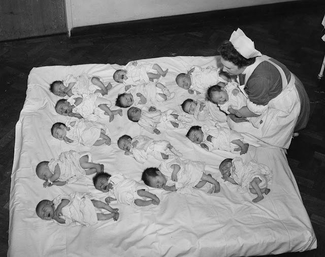 A staff nurse greets some new arrivals at the Queen Charlotte Hospital in London, 1945.