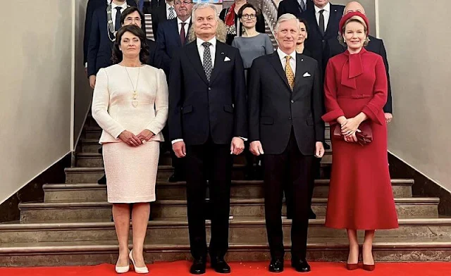 Queen Mathilde wore a hairy mohair red jacket and red wool crepe dress by Natan. Lithuanian First Lady Diana Nausedine