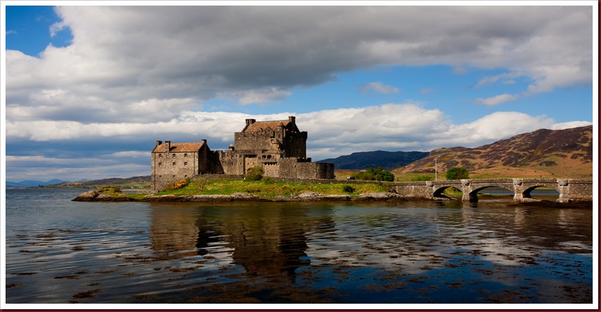 Eilean Donan Castle Photo of Eilean Donan Castle on a bright day with white clouds and blue sky