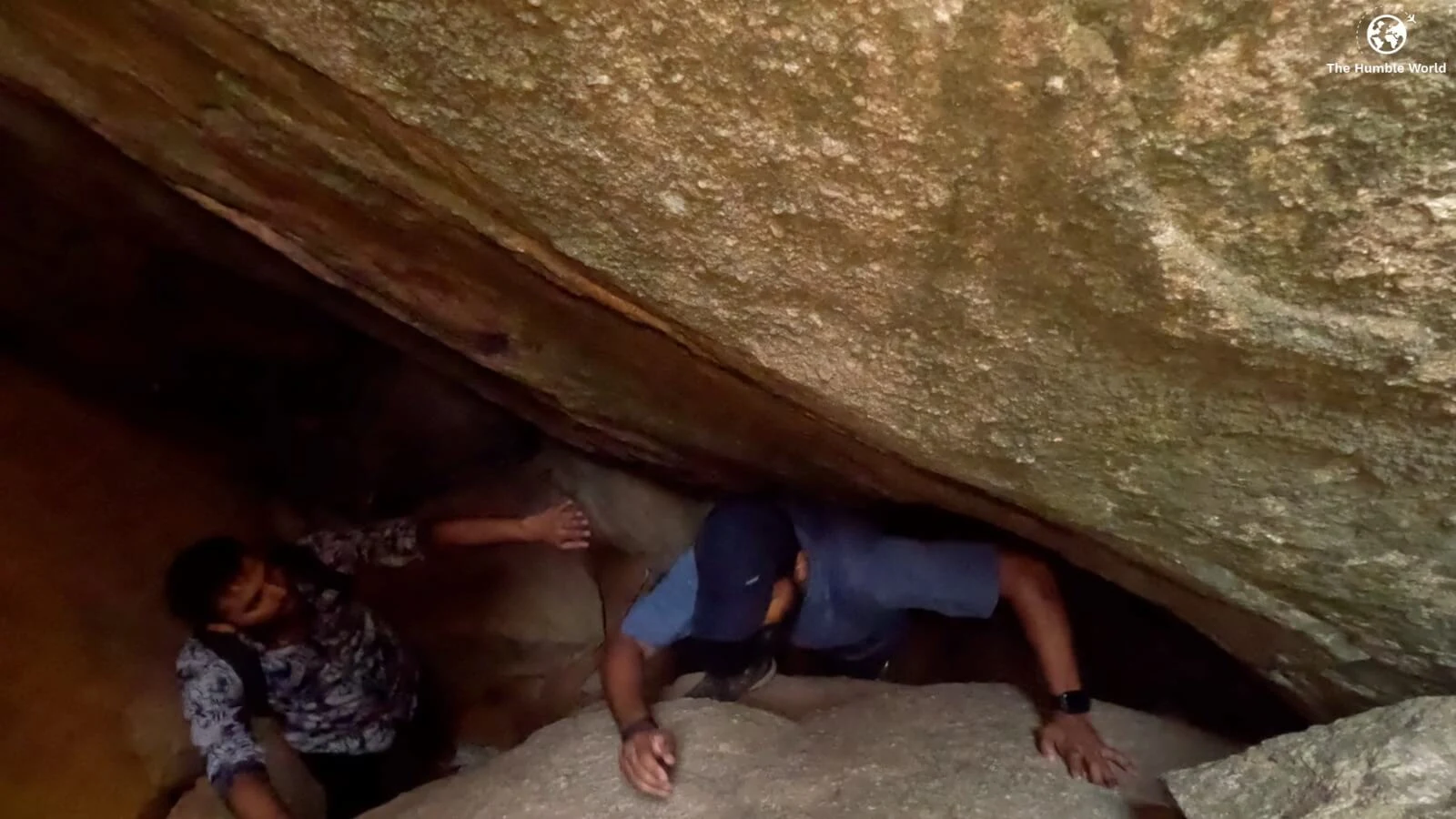 Struggling to climb the rock inside Anthargange caves