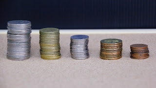 A stack of descending coins | Business debt collection Michigan