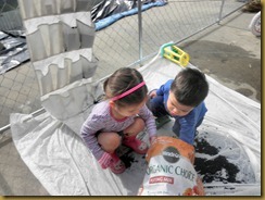 Sophia and Cohen planting herb garden