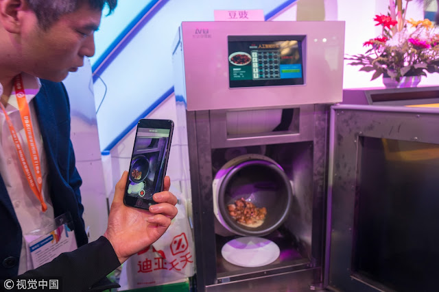 Chinese man invents smart robot cooker because of his wife's inability to cook