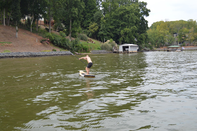 Dad falling off of the paddleboard.