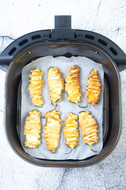 mummy poppers in an air fryer basket.