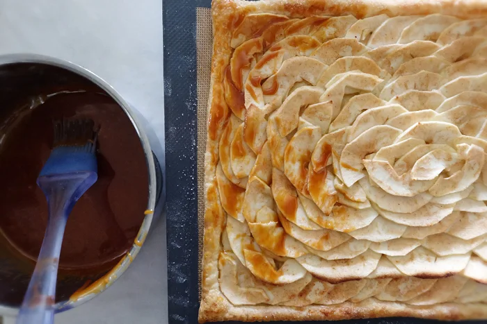 brushing partially baked tart with caramel