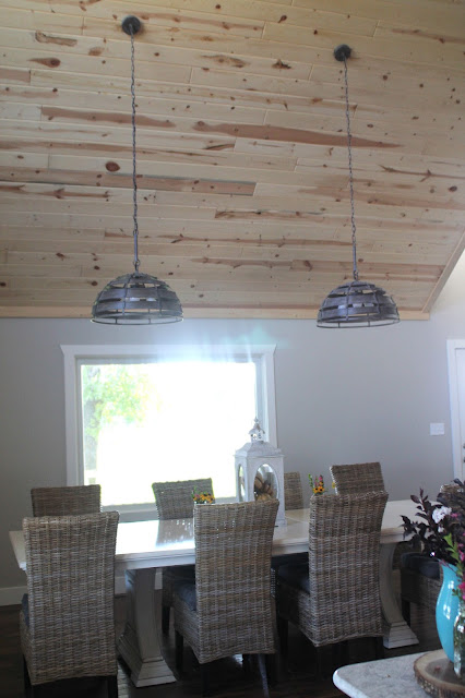 New table area with Pier One chairs, dining table and new lighting