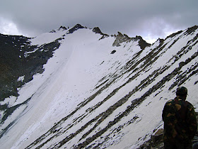 mountain top covered in a sheet of snow