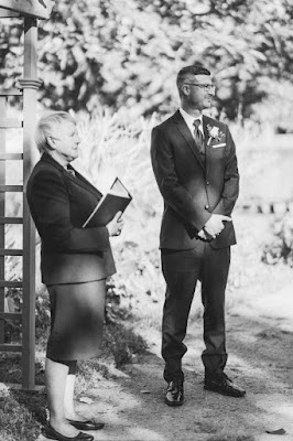 groom and officiant standing at the altar