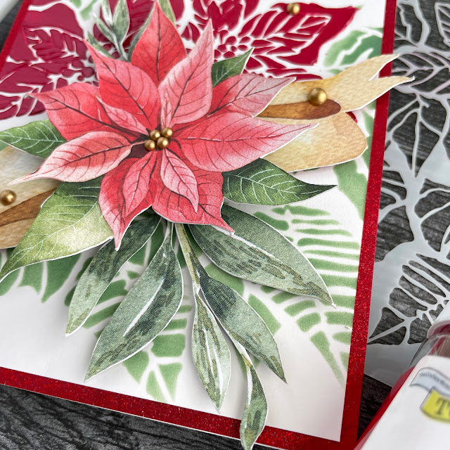 Poinsettia Christmas card created with: The Crafters Workshop poinsettia stencil, barn door stencil butter; Pinkfresh Studio matte gold pearls; P13 cosy winter red and green creative maxi pad; Scrapbook.com foam adhesive, mint tape; Tim Holtz - distress oxide rustic wildnerness