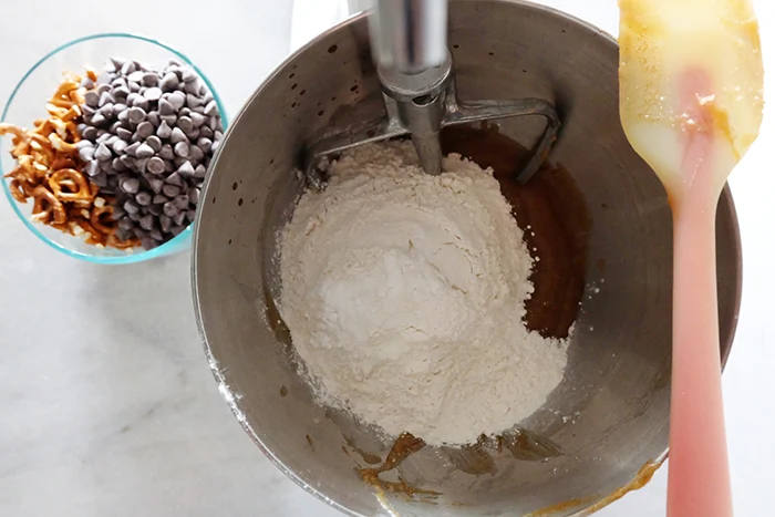 adding flour and dry ingredients to wet in mixer bowl