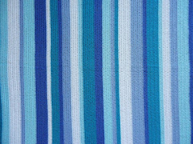 Looking for inspiration and ideas for a cute and easy stripy crochet blanket?  This is made in calm blue and green stripes, for a restful ocean feel.  Click to find out more details on the yarn and pattern used!