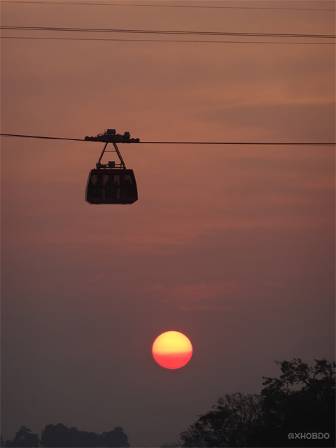 People travel in ropeway over the River Brahmaputra