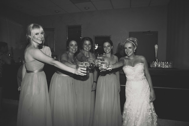 bride and bridesmaids doing a shot at reception at Fern Hill Golf Course