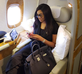 Chika Ike shows off her Hermes Birkin bag in first class seat..