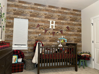 photo of crib with faux wood planks in nursery cabin theme buffalo plaid