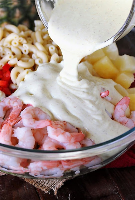 Pouring Dressing Over Ingredients to Make Pineapple Shrimp Macaroni Salad Image