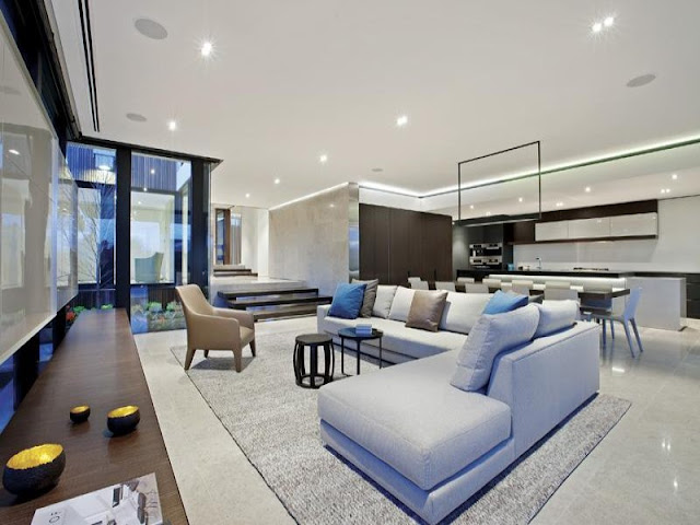 Photo of modern living room with the kitchen in the background 