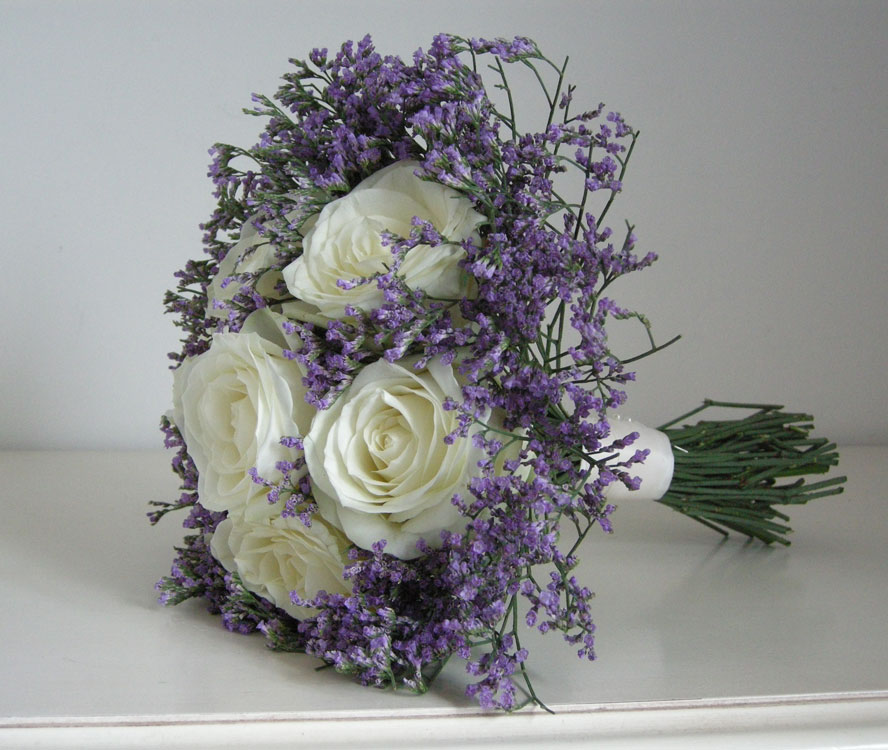 The bridesmaids carried bouquets of avalanche roses with lilac limonium