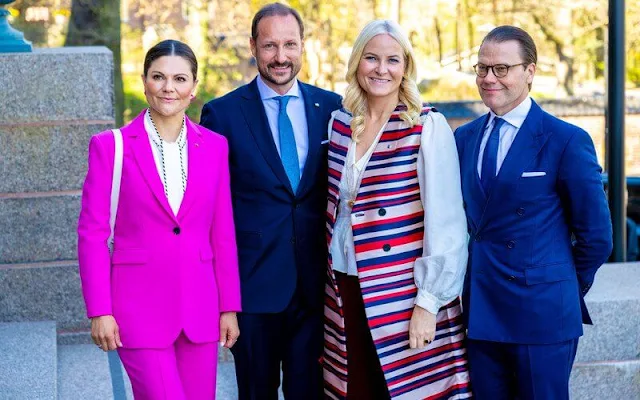 Princess Mette-Marit wore a satin trench coat by Tome, Princess Victoria wore a satin blouse by Peter Pilotto, and pink suit