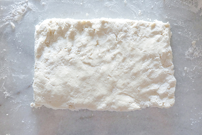 rectangle of cream biscuit dough on work surface