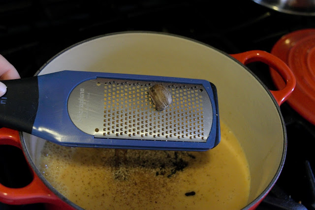 Nutmeg being grated into the creamer. 